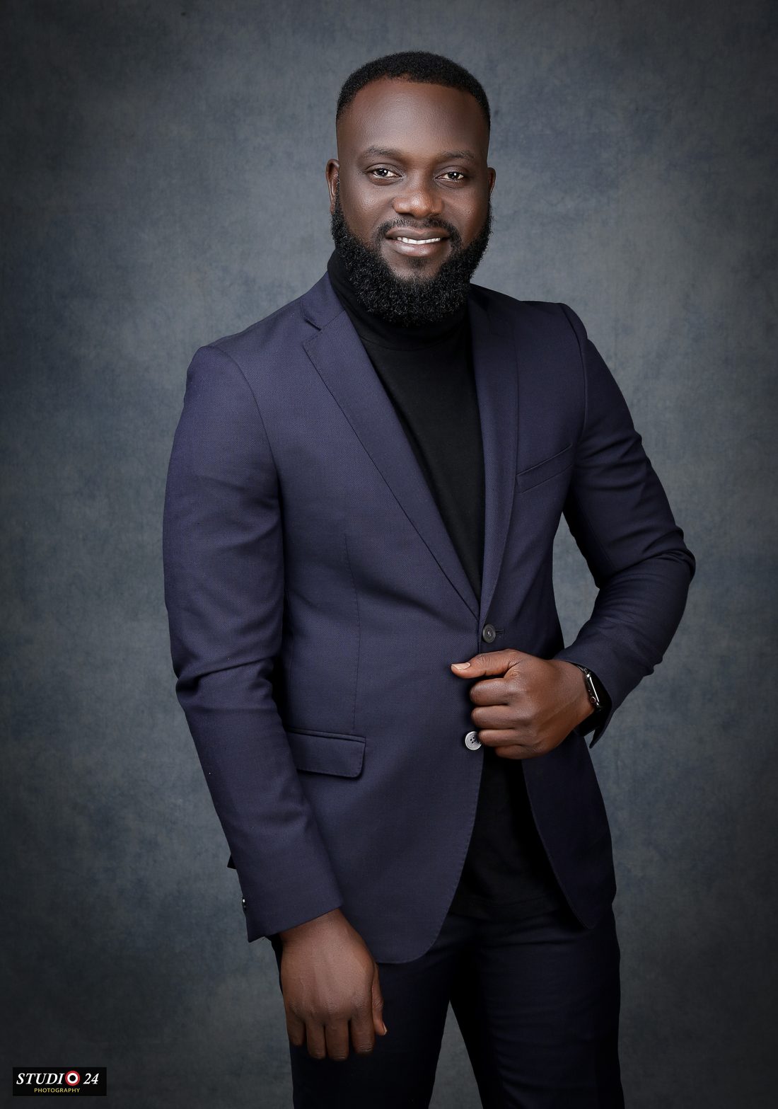 Dr. Abisoye Obayan in a navy suit and black turtleneck