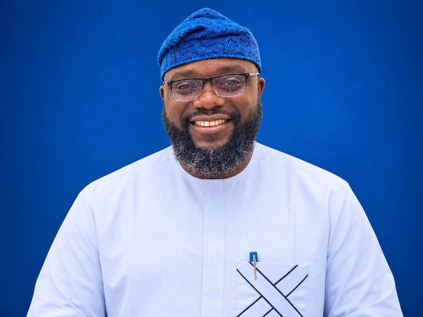 Bisoye Obayan smiling, wearing a light blue kaftan and a blue fila