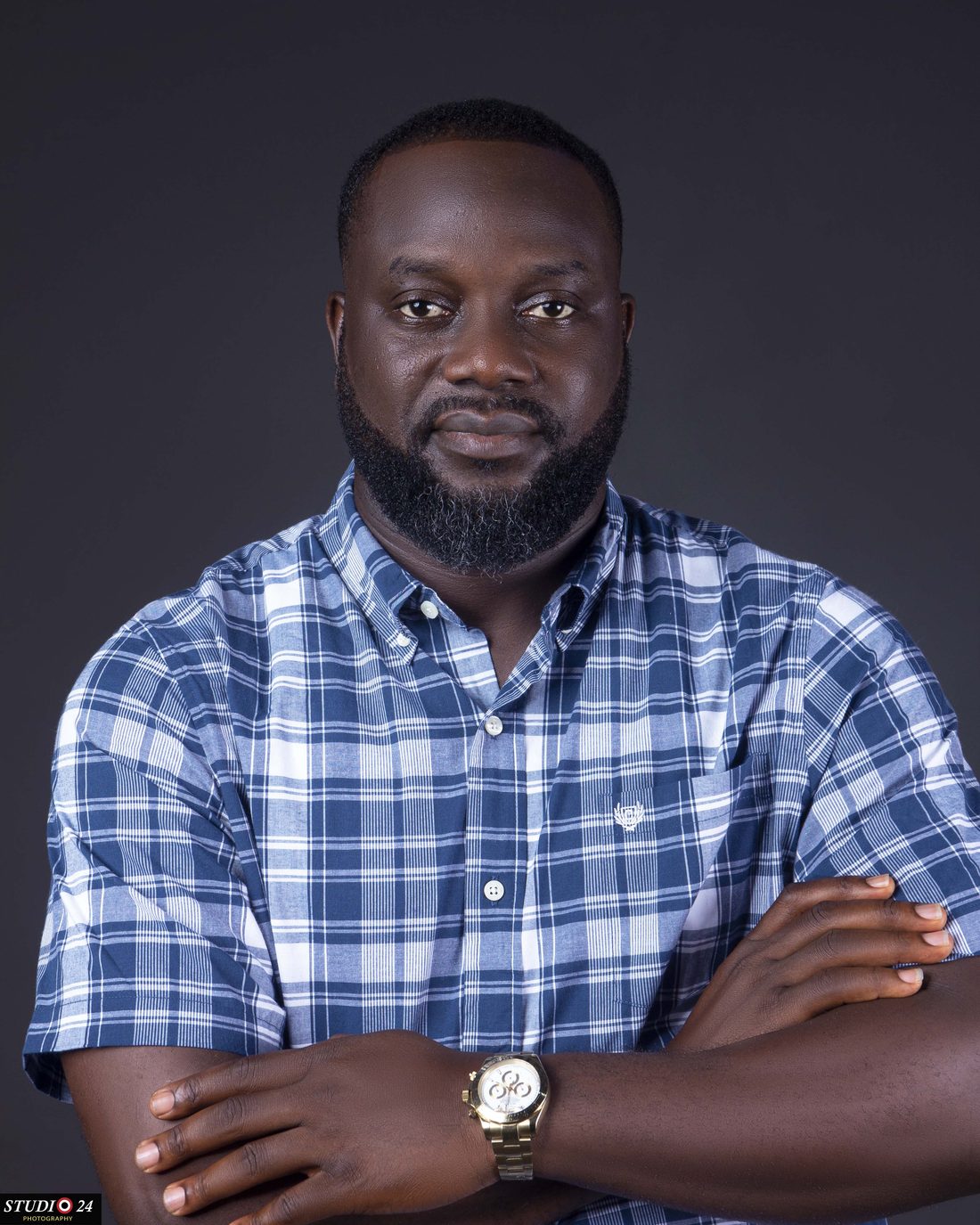 Bisoye Obayan in a checked shirt with arms folded